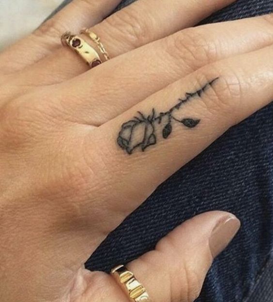 Piccolo tatuaggio di una rosa tatuata sul dito della mano